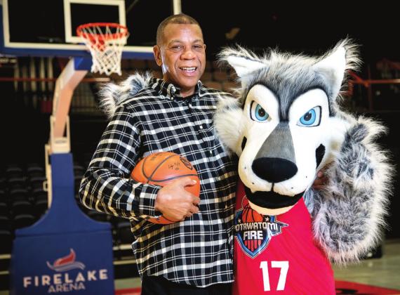 Potawatomi Fire Head Coach Derrick Rowland poses with Mo’ewé, or Mo, the team mascot. Mo’ewé (Mo-Eh-Weh) is the Potawatomi word for wolf. Photo provided by CPN