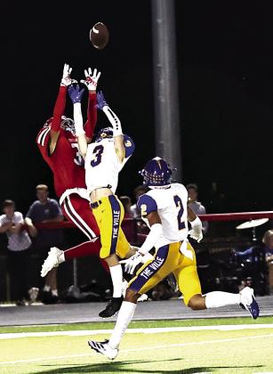 Left: Tyson Hawkins makes a great catch in the North Rock Creek home opener against Holdenville on Sept. 19.
