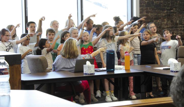 The Sequoyah Elementary School fourth-grade choir, led by Jana Stelzer, sing “Forward” during the Sept. 9 Shawnee Board of Education meeting. Countywide &amp; Sun/Natasha Dunagan