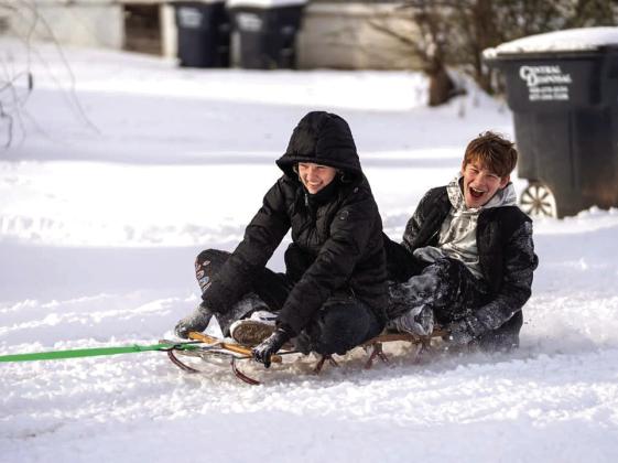 Mikayla Lorenzen froze this great moment of Tecumseh students, Addisyn, 15, and Bostyn, 11, being pulled on a sled by thier neighbor.