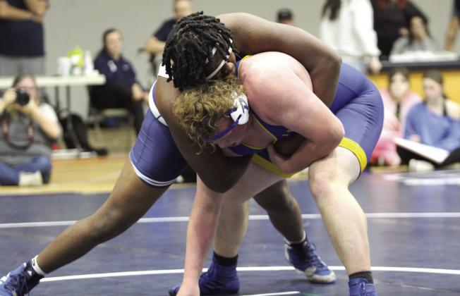 In the 285 weight class, Shawnee's JaQwon Evans works on bringing his Piedmont counterpart down during the home dual on Dec. 12. The Wolves lost, 23-53, and the Lady Wolves won, 42-23. Countywide &amp; Sun/Natasha Dunagan