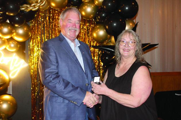 Countywide &amp; Sun Owner and Publisher Suzie Campbell, right, presents Randy Gilbert with his Pottawatomie Power Poll Top 10 lapel pin during the Awards Gala on Oct. 24. Gilbert placed ninth in the five-year event. Natasha Dunagan, Countywide &amp; Sun