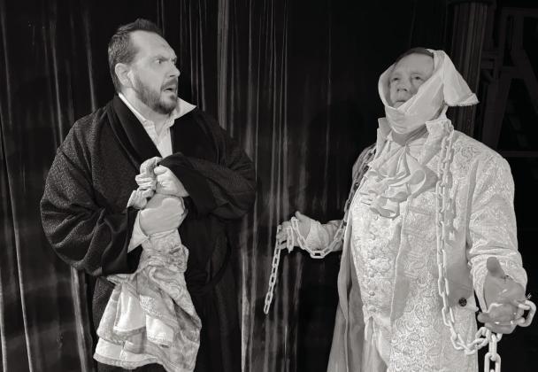 Scott Bartley (Ebinezer Scrooge) is frightened when he is visited by Robert Benton (a ghost of Christmas) in Shawnee Little Theatre’s production of “A Christmas Carol.” Photo provided by SLT