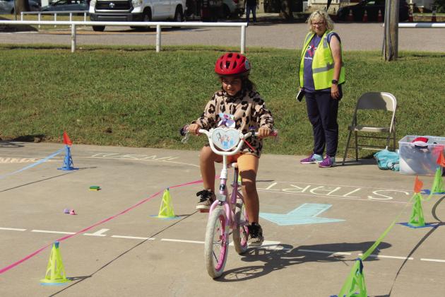Evie Satterwhite, 7, of Shawnee, begins the bicycle rodeo course, presented by Pottawatomie Go during Pedalpalooza, which was held at Rotary Briscoe Boy Scout Park on Sept. 20. In addition to the bike rodeo, there were several booths, including Epic Snocones, First United Bank, VIPS, Kids Action, Pioneer Library Systems - Shawnee Library, OBU, Willier USA, Salty Dogs Cycling, Mabee-Gerrer Museum of Art, and LOL Cartoons Party Entertainment. Natasha Dunagan, Countywide &amp; Sun