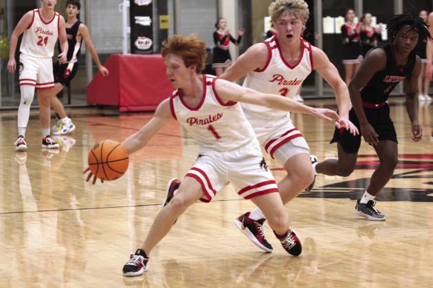 Dale’s Easton Edmonson recovers the ball as Denton Forsythe reacts during the third quarter of the Dec. 17 home game with Luther. The Pirates won, 80-45.