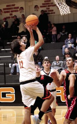 Maud’s Jordan Barnett goes in for the shot as others watch during the first quarter of the Maud vs Macomb home game on Nov. 29.