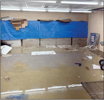Staff works quickly to get records out of the flooded basement. Approximatey 3-5 inches of water filled the entire basement on Tuesday.