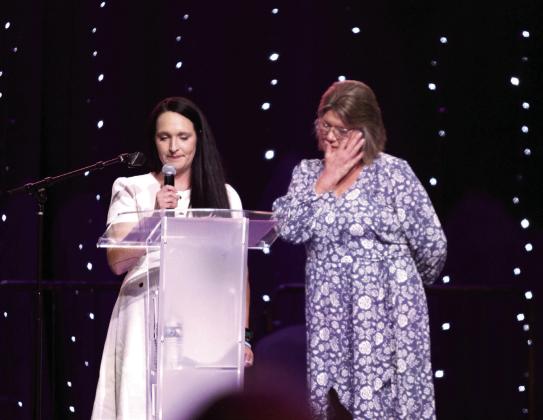 Bridget Saunders, right, wipes away a tear as her daughter Ashton Stiles tells about her experiences trying to escape from a violent man at the Project: SAFE 16th Annual Honey Do Auction on Oct. 3. Project: SAFE helped 1,984 clients in 2023, 86 percent of which were women. Countywide &amp; Sun/Natasha Dunagan