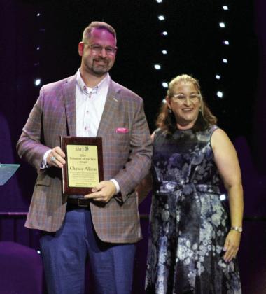 Project: SAFE Executive Director Renee Clemmons presents a Volunteer of the Year Award to Chance Allison.