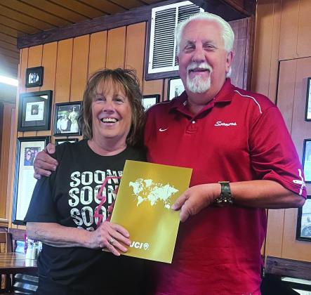 Oklahoma Junior Chamber International Senate President Randy Sursa presents Kimberly Rawls with a certificate, lapel pen and name badge, as he declares her to be a JCI Senator, during a meeting held at Van's Pig Stand in Shawnee on Aug. 23. Photo provided