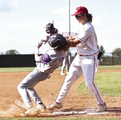 North Rock Creek’s Landon Kelough makes the tag at third. Photo courtesy of Gowin Photography