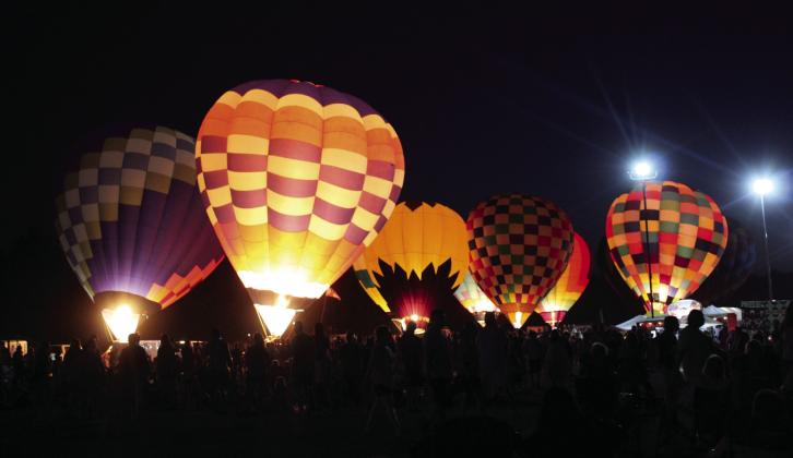 A record number of people attended the Fifth Annual FireLake Fireflight Balloon Festival on Aug. 12-13. There were 25 hot-air balloons from seven states that participated in balloon launches, tethered rides, and balloon glows, such as this one on Sat. night. Countywide &amp; Sun/Natasha Dunagan