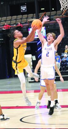 Tecumseh junior Marquan Krush goes to the hoop, as Bethel’s Xavier Meier guards it, during Bethel’s First United Basketball Classic on Dec. 8 at FireLake Arena. During the three-day tournament, the Savages lost to the Wildcats, 56-69, and to Clinton, 40-43, before winning, 82-12, over Astec Charter. Countywide &amp;amp; Sun/Natasha Dunagan