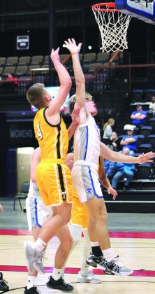 Tecumseh senior Brady Overstreet shoots over Bethel’s R.J. Morris during the tournament.