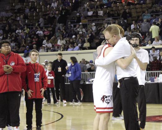 Dale senior Easton Edmonson gets a hug from his father and coach Jeff Edmonson after receiving his Class 2A Basketball State Championship medal on March 8. Natasha Dunagan, Countywide &amp; Sun