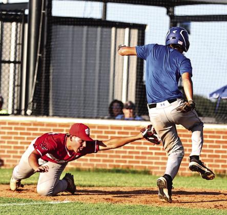 North Rock Creek's Kona Paningsoro stretches to tag the Harrah runner for the out at home. Photo courtesy of Gowin Photography