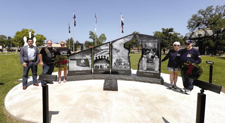 Sen. Shane Jett, Ralph “Rowdy” Butler, Donna Beth Warren, Linda Hendrickson, and David Hendrickson pose at the Gold Star Monument at Woodland Veterans Park in Shawnee after the memorial Memorial Day Service. Countywide &amp; Sun/Suzie Campbell