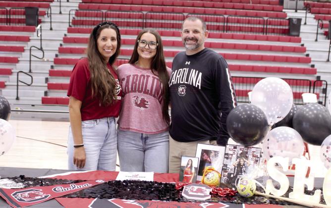 Dale senior Boo Herber, center, poses with her parents, Micaela and Bailey Herber. Herber has signed a letter of intent as a softball pitcher with the University of South Carolina. Herber has reached 840 strike-outs in her high school career, made All-State and will serve as a Dale Valedictorian.
