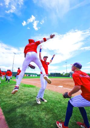 Alt Text for ImagePhoto Provided Cohl McCoy of Fort Worth, Texas, left, and Dylan Restine of Panama, right, celebrate with Brayden Harpole of Burkburnett, Texas, center, during the JUCO World Series. Photo Provided