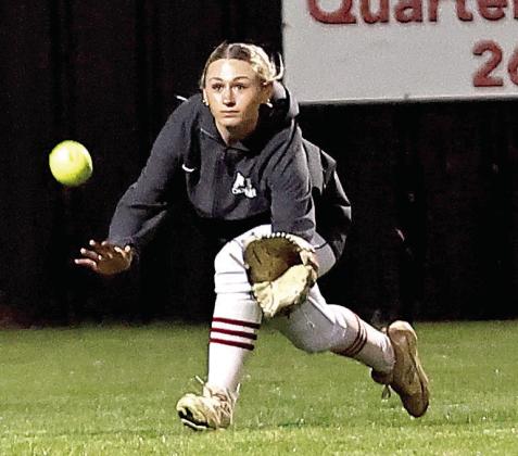 North Rock Creek's Lainey Joyner stretches out to make the catch. NRC softball team won Tuesday, Apr. 8, against Yukon (13-2) and Deer Creek (10-5). Photo courtesy of Gowin Photography