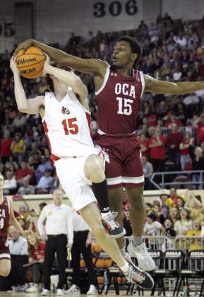 Dale junior Seth Smelser tries for a basket but is fouled in the fourth quarter of the Class 2A State Championship game against OCA, held at the State Fairgrounds Arena on March 11.