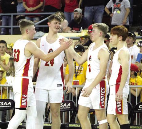 Dale junior Dayton Forsythe clasps hands with his brother, Dale freshman Denton Forsythe, as teammates Trayden Chambers (#24) and Easton Edmonson look on, during the Class 2A State Championship on March 11. The Pirates’ starters sat out the last couple minutes of the game so their teammates could play. They won, 78-52.