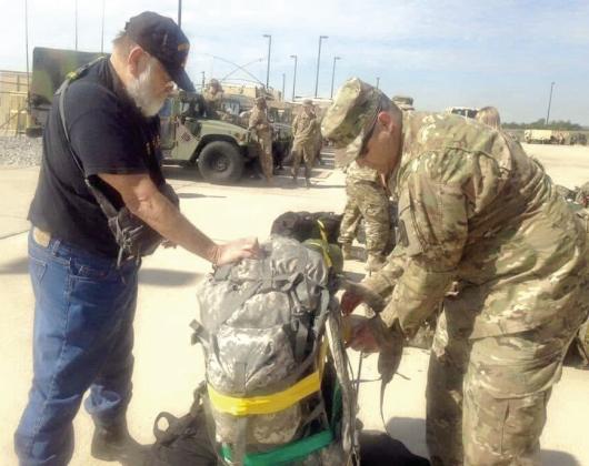 Vietnam Veteran, Staff Sgt. Timothy Lawrence, of Shawnee, helps his grandson, Dale graduate Major Jerame Johnson, to prepare for deployment to Qatar from Fort Sill in Lawton in 2016. Both veterans retired from the Army after at least 20 years. Lawrence's family recently found his memoir and had it published, seven years after his passing — "leaving something behind so we could understand where he came from and what shaped him.” Photos provided