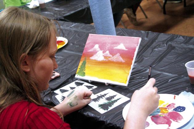 Olivia Hill, summer volunteer at the Tecumseh Public Library, paints a nature landscape at the library’s Summer Learning Event on Wednesday, June 21. Countywide &amp;amp; Sun/Valerie Scott