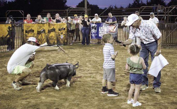Swine show Judge Colton Blehm interviews contestants in order to split the winnings between them at the T-Town Showdown.