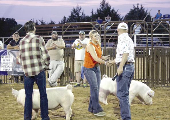Austyn Wood of McLoud shakes hands with the judge, Colton Blehm, after winning the Senior Showmanship division of the T-Town Showdown on Aug. 26. The second annual swine show was presented by the Tecumseh 4-H &amp; FFA Booster Club at the Tecumseh Round-Up Club Arena. Countywide &amp;amp; Sun/Natasha Dunagan