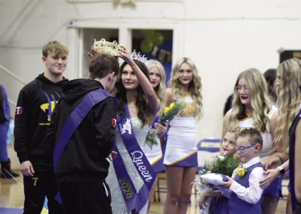 Bethel Homecoming Wrestling Queen Chloe Epperley crowns Blake Griffith as King during the ceremonies on Jan. 25, as flower girl Laynie Peltier and crown bearer Remington Hayes look on. Countywide &amp; Sun/Natasha Dunagan