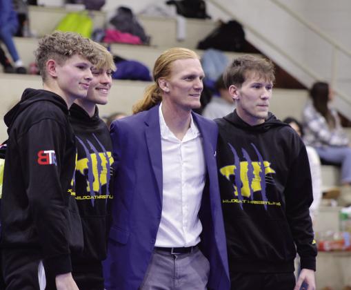 Bethel wrestling seniors, from left, Ryan Clawson, Brady Lower and Blake Griffith, pose with Bethel Head Wrestling Coach Aaron Smith during Senior Night on Jan. 25.
