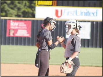 Tecumseh senior Serenity Jacoway and junior Jessi Hull share their secret handshake during the Class 4A Fastpitch Softball Super Regionals on Oct. 5. This was in the second of three games with Blanchard over two days. The Lady Savages won the first game, 11-4; lost the second game, 2-4; and lost the third game in overtime, 6-8. They finish the season with a record of 32-6. Countywide &amp; Sun/Natasha Dunagan
