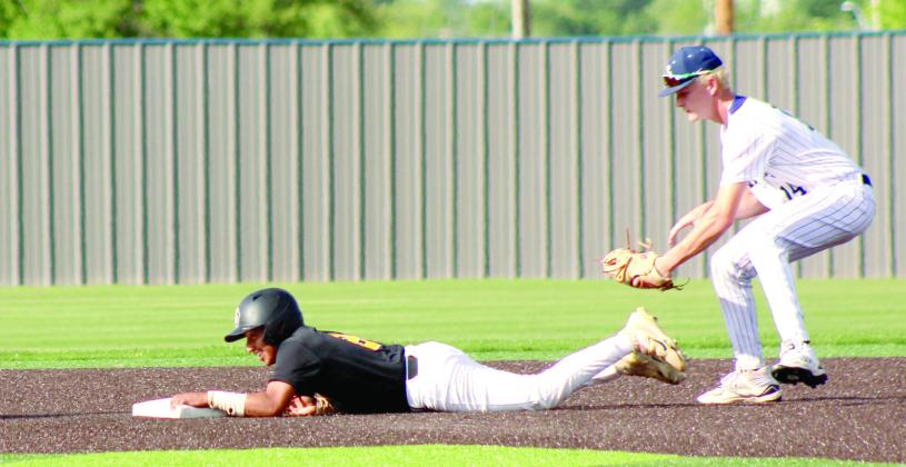 Shawnee sophomore Ty Janda tries to tag a runner who dove back to second base in the May 5 home game with Santa Fe South.