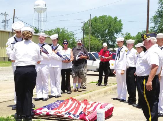 U.S. Naval Sea Cadets Radomir Baker and Diana Murray unfold a flag to be retired by fire, as fellow Sea Cadets and community members wait to contribute their flags at American Legion Hill-Huett Post 260, in Tecumseh, on June 11. Besides retiring the flags, their Flag Day ceremony included the explanation of the folds when folding a flag, Sea Cadet Anna O’Dell reading “The Rugged, Old Flag,” American Legion District Commander Jimmy Keene speaking about the history of the U.S. Flag, and a 21-gun salute by the