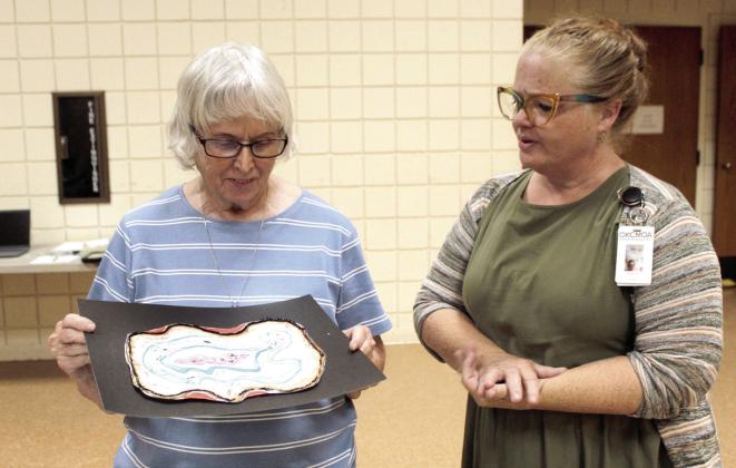 Arthenia Haney, left, talks with Amanda Clay, with the OKC Museum of Art, about her finished artwork during the "Mixed Media Geode Drawings" Program at Tecumseh Public Library on June. 23. During the school year, Clay is an elementary school librarian in Putnam City and has been in education for 35 years.