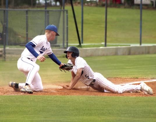 Asher sophomore Aiden Dodge dives to steal third and is safe in the Class B Regional Baseball Tournament.