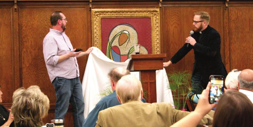 Emmanuel Episcopal Church Rector Tom Dahlman (right) unveils a mosaic by Julie Blackstone depicting the parish logo, at the parish’s 125th Anniversary dinner, Saturday night. Countywide &amp;amp; Sun/Kendra Johnson