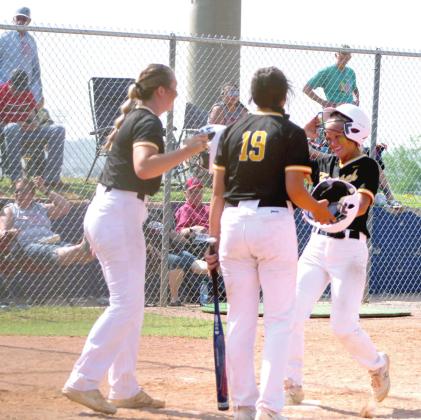 Tecumseh senior Lauren Taylor taps helmets with her teammates after she hit a home run in the third inning of the Class 5A State Tournament Quarterfinal game against Stilwell, held at the USA Softball Hall of Fame on May 9. The Lady Savages slow-pitch softball team won, 14-8, but they fell in the Semifinals, 1-5, to Perkins-Tryon that same day. They end their season with a record of 29-8. Countywide &amp;amp; Sun/ Natasha Dunagan