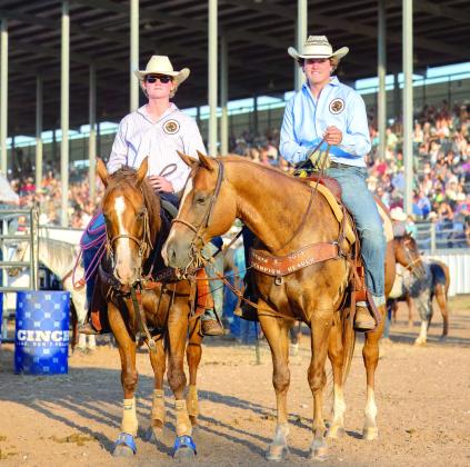 Brothers Landen and Hayden Youngblood, of Shawnee, pose after team roping at the International Finals Youth Rodeo on July 10. They follow in the footsteps of their father, Ryan, who also competed in team roping as a teen and was a Tecumseh graduate. Photo courtesy of Richelle Treece.