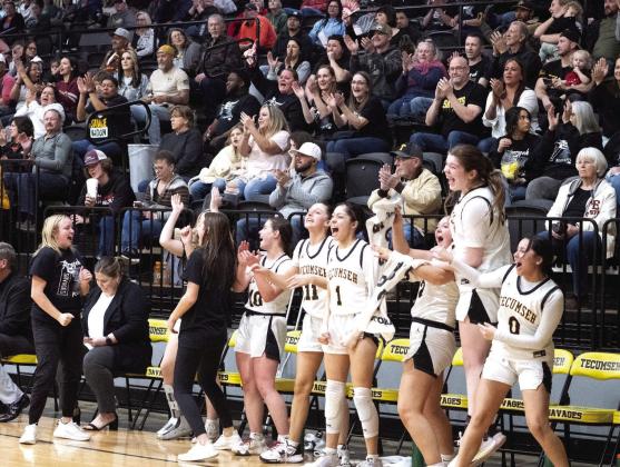 The Tecumseh Lady Savage starters cheer from the bench during the second half of the Class 4A District game with Crossings Christian on Feb. 17. They won the district championship, 79-26. Photo provided by Kenetta Lisenbee.