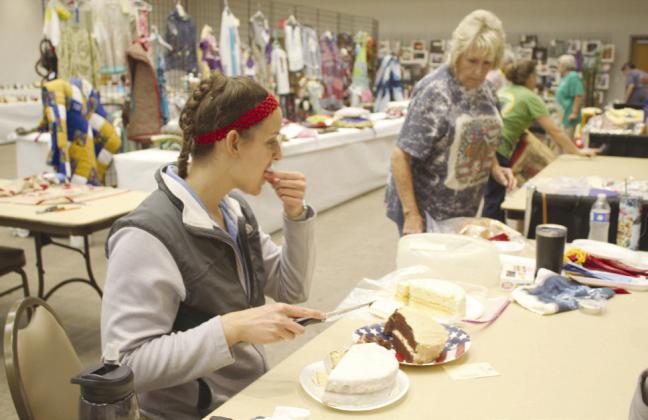 Shawnee Milling Company Production Developer Mackenna Heath judges three cakes, as Oklahoma Home and Community Education (OHCE) Dale Chapter member Laqueda Steward keeps her supplied with baked goods before they are awarded ribbons and put on display at the Pottawatomie County Free Fair. File photo