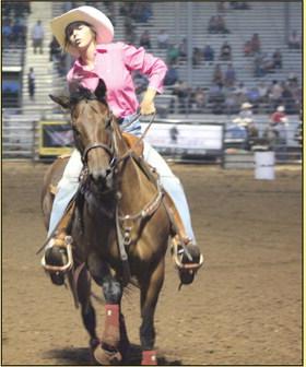 Bella Branham of Tecumseh slows her horse after her barrel ride at the IFYR. See more photos on B1 and B6.