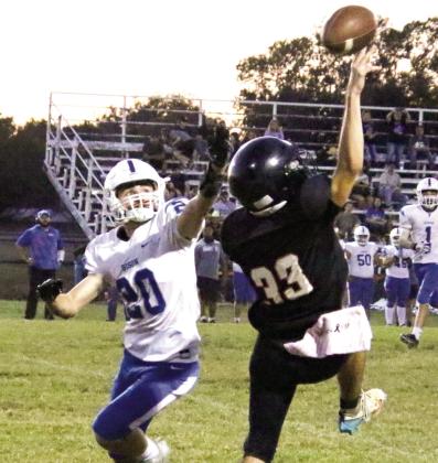 Maud senior Daniel Thompson (#33) and a Bowlegs player both reach for a pass during the Maud home game on Oct. 10. The Tigers won 44-8.
