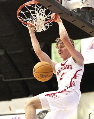 North Rock Creek's Kohen Warden dunks the ball during the first game of the Okemah tournament on Dec. 11. The boys beat Hilldale 59-24. Photos Provided by Gowin Photography