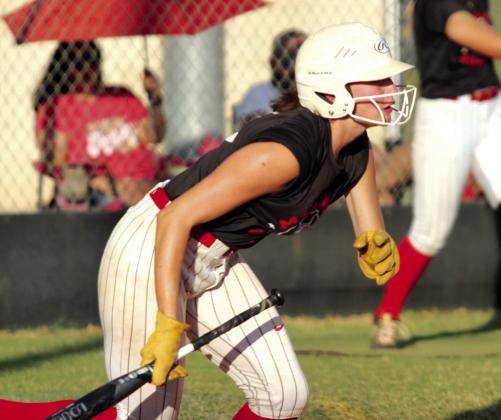 McLoud’s Alivia Scott drops the bat and runs after hitting a single in the Sept. 19 game at Tecumseh. The Lady Redskins lost to the Lady Savages, 5-3. Countywide &amp; Sun/Natasha Dunagan