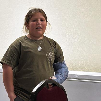 Macomb 4th-grade student Tinsley Perez sang The Star Spangled Banner for attendees as county officials finished paperwork from the election. Countywide &amp; Sun/Suzie Campbell