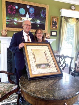 Creators Ed and Sandy Moore pose with the Declaration of Dependence during the Grand Opening celebration of the Children's White House at Shawnee Twin Lakes. Moore had an official signing at 2:50 pm by those in attendance on Flag Day to commemorate America's 250th birthday. Photo Provided by April Grant.