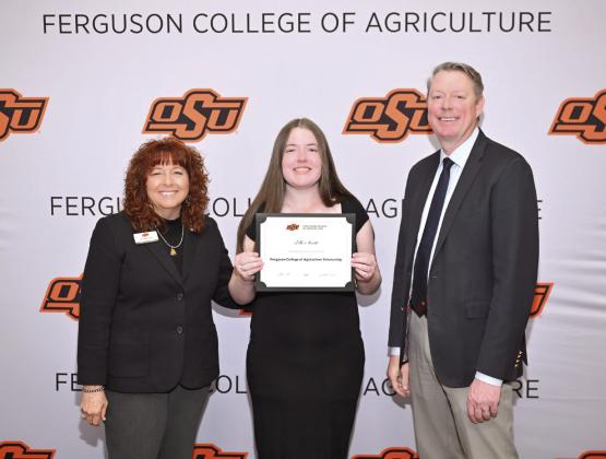 Cynda Clary, associate dean for academic programs and Jayson Lusk, dean for the Ferguson College of Agriculture, present Elle Scott with a scholarship Photo provided by OSU