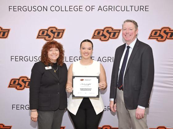 Cynda Clary, associate dean for academic programs and Jayson Lusk, dean for the Ferguson College of Agriculture, present (Morley Griffith) with a scholarship. Photo provided by OSU